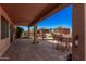 Relaxing outdoor patio with tile flooring, bar seating, and multiple palm trees at 1902 S Rialto -- # Mesa, Mesa, AZ 85209