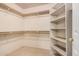 Walk-in closet with ample shelving and rod space for organized storage at 1902 S Rialto -- # Mesa, Mesa, AZ 85209