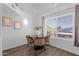 Bright dining area featuring a modern table, stylish chairs, and large window for ample natural light at 19601 N 7Th St # 2095, Phoenix, AZ 85024