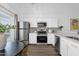 Modern kitchen with stainless steel appliances, white cabinets, decorative backsplash and bright light at 19601 N 7Th St # 2095, Phoenix, AZ 85024