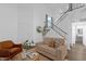 Inviting living room with a cozy couch, accent chair, and stylish staircase, perfect for relaxing and entertaining at 19601 N 7Th St # 2095, Phoenix, AZ 85024