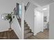 View of carpeted staircase leading to the second floor with a nearby powder room at 19601 N 7Th St # 2095, Phoenix, AZ 85024