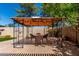 Landscaped backyard with a gazebo featuring table and chairs for outdoor entertainment at 2244 E Rawhide St, Gilbert, AZ 85296