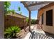 Landscaped backyard with stone tile, mature landscaping and a privacy fence at 2244 E Rawhide St, Gilbert, AZ 85296