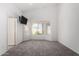 Neutral bedroom featuring vaulted ceilings, natural light, and plush carpet creating a soothing ambiance at 2244 E Rawhide St, Gilbert, AZ 85296