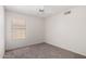 Cozy bedroom with neutral carpet, ceiling fan, and a window perfect for natural light at 2244 E Rawhide St, Gilbert, AZ 85296