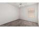 This bedroom features neutral walls and carpet with a ceiling fan and window for natural light at 2244 E Rawhide St, Gilbert, AZ 85296