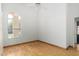 Bright bedroom with light wood floors, white walls, ceiling fan, and ample natural light at 2244 E Rawhide St, Gilbert, AZ 85296