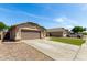 Charming single-story home with a two-car garage, desert landscaping, and a long driveway at 2244 E Rawhide St, Gilbert, AZ 85296