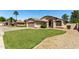 Traditional style home with an arched entryway, green lawn, desert landscaping, and a two-car garage at 2244 E Rawhide St, Gilbert, AZ 85296