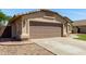 Attached two-car garage with updated paint, desert landscaping, and walkway to the front door at 2244 E Rawhide St, Gilbert, AZ 85296