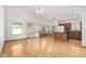 Open-concept living room with hardwood floors, vaulted ceiling, and access to the kitchen at 2244 E Rawhide St, Gilbert, AZ 85296