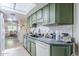 Bright kitchen with updated backsplash, green cabinets, and a sunny skylight at 2311 S Farnsworth Dr # 81, Mesa, AZ 85209