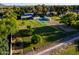 Aerial view of house with large yard, tennis court and desert landscaping at 2350 E Melrose St, Gilbert, AZ 85297