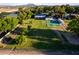 Aerial view of property featuring a tennis court and vast lawn at 2350 E Melrose St, Gilbert, AZ 85297