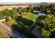 Expansive backyard featuring lush lawn, mature trees, and a full-sized tennis court for recreation and outdoor enjoyment at 2350 E Melrose St, Gilbert, AZ 85297