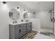 Modern bathroom featuring a double sink vanity, sleek fixtures, and a walk-in shower with stylish subway tile at 2350 E Melrose St, Gilbert, AZ 85297