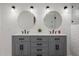 Modern bathroom featuring a double sink vanity, sleek fixtures, and wall mirrors at 2350 E Melrose St, Gilbert, AZ 85297