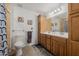 Traditional bathroom features a dual sink vanity, a mirrored wall cabinet and updated fixtures at 2350 E Melrose St, Gilbert, AZ 85297