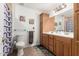 Bathroom featuring double sink vanity, decorative mirror, and neutral tile flooring at 2350 E Melrose St, Gilbert, AZ 85297