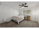 Welcoming bedroom with neutral carpet includes ceiling fan, window, and hardwood side table at 2350 E Melrose St, Gilbert, AZ 85297