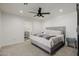 Comfortable bedroom boasts neutral carpet, a ceiling fan, and an attached bath for added convenience at 2350 E Melrose St, Gilbert, AZ 85297
