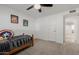 Inviting bedroom with neutral carpet features a ceiling fan, closet, and light paint color at 2350 E Melrose St, Gilbert, AZ 85297