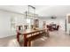 Sunlit dining room with wooden table, bench, seating, and modern light fixture at 2350 E Melrose St, Gilbert, AZ 85297