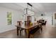 Bright dining room boasts a large wooden table with ample seating and modern light fixture at 2350 E Melrose St, Gilbert, AZ 85297