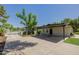 Long driveway with carport and a glimpse of the tennis court and the garage at 2350 E Melrose St, Gilbert, AZ 85297
