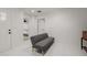 Bright hallway featuring a gray bench, with views into the main bedroom at 2350 E Melrose St, Gilbert, AZ 85297