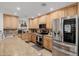 Modern kitchen with light wood cabinets, stainless steel appliances, and granite countertops at 2350 E Melrose St, Gilbert, AZ 85297