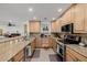 Spacious kitchen featuring granite countertops, stainless steel appliances, and breakfast bar at 2350 E Melrose St, Gilbert, AZ 85297