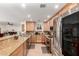 Well-lit kitchen featuring granite countertops, stainless steel appliances, and wooden cabinetry at 2350 E Melrose St, Gilbert, AZ 85297