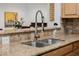 Close up of kitchen sink with stainless steel faucet and granite countertops at 2350 E Melrose St, Gilbert, AZ 85297