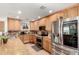 Well-lit kitchen featuring granite countertops, stainless steel appliances, and wooden cabinetry at 2350 E Melrose St, Gilbert, AZ 85297