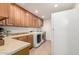 Laundry room with front loading washer and dryer, cabinets, and counter space at 2350 E Melrose St, Gilbert, AZ 85297