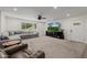 Bright living room featuring a large sectional sofa, a TV and a ceiling fan at 2350 E Melrose St, Gilbert, AZ 85297