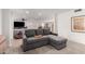 Comfortable living room area featuring a gray pull out sofa with chaise lounge at 2350 E Melrose St, Gilbert, AZ 85297
