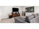 Cozy living area with comfortable gray sofa, entertainment center, and natural light at 2350 E Melrose St, Gilbert, AZ 85297