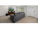 Cozy living room with small sofa, tv, and a window at 2350 E Melrose St, Gilbert, AZ 85297