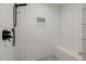 Contemporary shower featuring subway tile walls, a built-in niche, and a hexagon tile shower floor at 2350 E Melrose St, Gilbert, AZ 85297