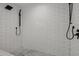 Modern shower with subway tile walls, dual shower heads, and a hexagon tile shower floor at 2350 E Melrose St, Gilbert, AZ 85297