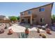 Wide backyard showing patio, rock desert landscaping, a covered patio, and a two-story home at 26062 W Potter Dr, Buckeye, AZ 85396