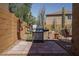 Backyard with desert landscaping with a built in outdoor grill, and a seating area at 26062 W Potter Dr, Buckeye, AZ 85396