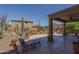 Relaxing backyard patio with desert landscape, rock features, and an inviting seating area at 26062 W Potter Dr, Buckeye, AZ 85396