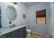 Modern bathroom with marble vanity, stylish fixtures, and a neutral color scheme at 26062 W Potter Dr, Buckeye, AZ 85396