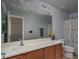 Bathroom featuring a vanity, large mirror, modern fixtures, and a decorative shower curtain at 26062 W Potter Dr, Buckeye, AZ 85396