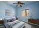 Stylish bedroom with a modern bed, elegant artwork, and bright natural light at 26062 W Potter Dr, Buckeye, AZ 85396
