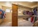 Spacious walk-in closet offers ample storage with built-in shelves and organized racks at 26062 W Potter Dr, Buckeye, AZ 85396